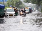 Commuters wade through a waterlogged road after heavy rainfall, at ITO, in New Delhi on Tuesday.(ANI Photo) Commuters wade through a waterlogged road after heavy rainfall, at ITO, in New Delhi on Tuesday.(ANI Photo)