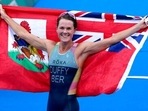 Gold medalist Flora Duffy of Bermuda celebrates after winning the women's individual triathlon competition at the 2020 Summer Olympics. Gold medalist Flora Duffy of Bermuda celebrates after winning the women's individual triathlon competition at the 2020 Summer Olympics.