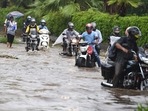 Commuters wade through a waterlogged Ring Road during monsoon rains in New Delhi, Tuesday, July, 27, 2021. Commuters wade through a waterlogged Ring Road during monsoon rains in New Delhi, Tuesday, July, 27, 2021.