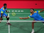 India's Chirag Shetty (R) hits a shot next to India's Satwiksairaj Rankireddy. 
