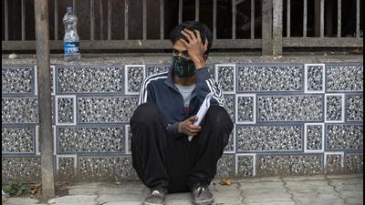 Attendant of a Covid patient waits outside a hospital in Srinagar. (Image for representational purpose (AP File Photo)) Attendant of a Covid patient waits outside a hospital in Srinagar. (Image for representational purpose (AP File Photo))