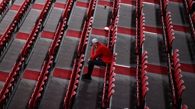 A man sits among rows of empty seats at the Tokyo Metropolitan Gymnasium (REUTERS)