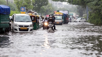 Commuters wade through a waterlogged road after heavy rainfall, at ITO, in New Delhi on Tuesday. (ANI Photo) Commuters wade through a waterlogged road after heavy rainfall, at ITO, in New Delhi on Tuesday. (ANI Photo)