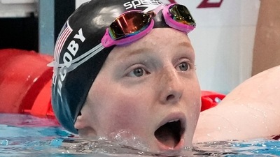 Lydia Jacoby, of the United States, reacts after winning the final of the women's 100-meter breaststroke at the 2020 Summer Olympics. (AP)