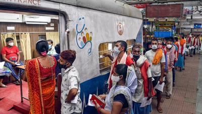 Porters wait in a queue for Covid-19 vaccine dose during a camp at Sealdah station in Kolkata on July 22. (PTI) Porters wait in a queue for Covid-19 vaccine dose during a camp at Sealdah station in Kolkata on July 22. (PTI)