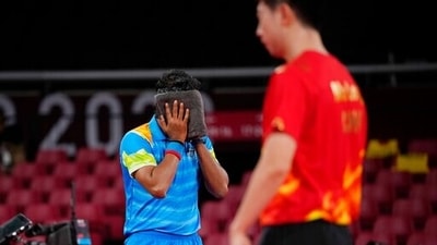 India's Achanta Kamal wipes his face during the table tennis men's singles third round match against China's Ma Long at the 2020 Summer Olympics, Tuesday, July 27, 2021, in Tokyo. (AP Photo/Kin Cheung) (AP) India's Achanta Kamal wipes his face during the table tennis men's singles third round match against China's Ma Long at the 2020 Summer Olympics, Tuesday, July 27, 2021, in Tokyo. (AP Photo/Kin Cheung) (AP)