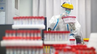 A health worker in protective suit works at a nucleic acid testing laboratory in a hospital in Nanjing, China on July 24, 2021. (REUTERS/FILE)