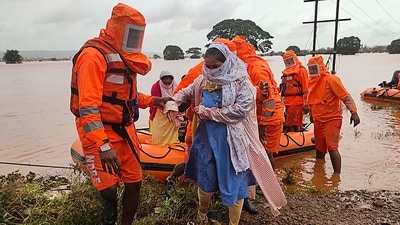 India's National Disaster Response Force (NDRF), shows NDRF personnel rescuing stranded villagers from flooded areas following heavy monsoon rains in Balinge village of Kolhapur district of Maharashtra. (AFP) India's National Disaster Response Force (NDRF), shows NDRF personnel rescuing stranded villagers from flooded areas following heavy monsoon rains in Balinge village of Kolhapur district of Maharashtra. (AFP)