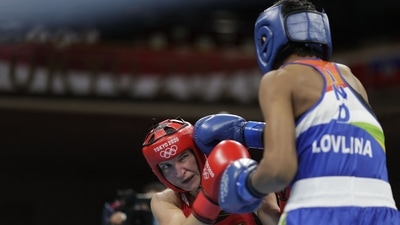 Germany's Nadine Apetz (red) and India's Lovlina Borgohain fight during their women's welter (64-69kg) preliminaries round of 16 boxing match during the Tokyo 2020 Olympic Games at the Kokugikan Arena in Tokyo on July 27, 2021. (Photo by UESLEI MARCELINO / POOL / AFP) (AFP) Germany's Nadine Apetz (red) and India's Lovlina Borgohain fight during their women's welter (64-69kg) preliminaries round of 16 boxing match during the Tokyo 2020 Olympic Games at the Kokugikan Arena in Tokyo on July 27, 2021. (Photo by UESLEI MARCELINO / POOL / AFP) (AFP)