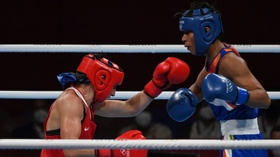 Germany's Nadine Apetz (red) and India's Lovlina Borgohain fight during their women's welter (64-69kg) preliminaries round of 16 boxing match during the Tokyo 2020 Olympic Games at the Kokugikan Arena in Tokyo on July 27, 2021. (Photo by Luis ROBAYO / AFP) (AFP) Germany's Nadine Apetz (red) and India's Lovlina Borgohain fight during their women's welter (64-69kg) preliminaries round of 16 boxing match during the Tokyo 2020 Olympic Games at the Kokugikan Arena in Tokyo on July 27, 2021. (Photo by Luis ROBAYO / AFP) (AFP)