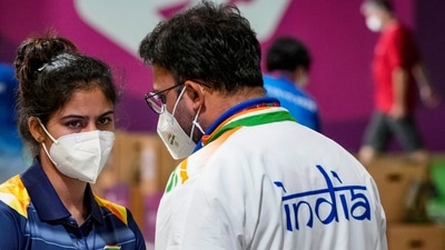 Tokyo: India's Manu Bhaker discusses with coach Round Pandit after competing in the 10m Air Pistol Mixed Team shooting event, at the Summer Olympics 2020, in Tokyo, Tuesday, July 27, 2021. (PTI Photo/Gurinder Osan)(PTI07_27_2021_000011A) (PTI) Tokyo: India's Manu Bhaker discusses with coach Round Pandit after competing in the 10m Air Pistol Mixed Team shooting event, at the Summer Olympics 2020, in Tokyo, Tuesday, July 27, 2021. (PTI Photo/Gurinder Osan)(PTI07_27_2021_000011A) (PTI)