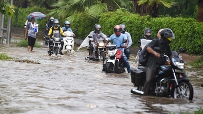 Commuters wade through a waterlogged Ring Road during monsoon rains in New Delhi, Tuesday, July, 27, 2021. (PTI) Commuters wade through a waterlogged Ring Road during monsoon rains in New Delhi, Tuesday, July, 27, 2021. (PTI)