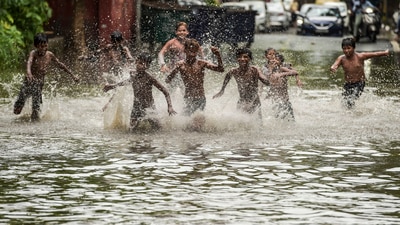 Children play on a waterlogged street after heavy rains near ITO in New Delhi. (PTI) Children play on a waterlogged street after heavy rains near ITO in New Delhi. (PTI)