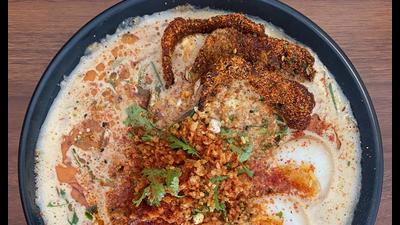 Spicy garlic ramen with fried pork chashu, ajitama, fried garlic, cilantaro, chillies and black garlic Spicy garlic ramen with fried pork chashu, ajitama, fried garlic, cilantaro, chillies and black garlic