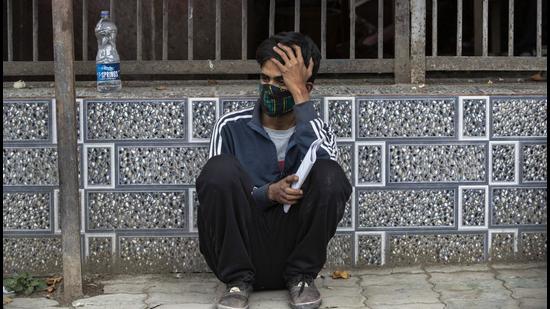 Attendant of a Covid patient waits outside a hospital in Srinagar. (Image for representational purpose (AP File Photo))