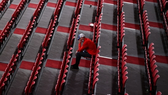  A man sits among rows of empty seats at the Tokyo Metropolitan Gymnasium (REUTERS)