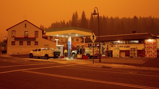 Firefighters gas up while battling the Dixie Fire in the Greenville community of Plumas County, California on July 23. Rescue workers have been dispatched from as far away as Florida to help contain the Dixie Fire and its pyrocumulus clouds.(Noah Berger / AP)