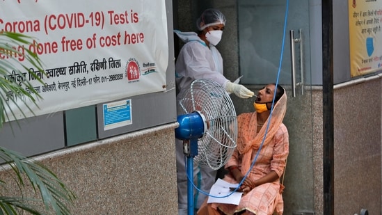 A health worker takes a sample to test for Covid-19 in New Delhi. (AP Photo)