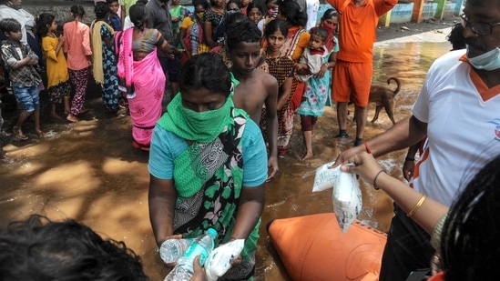India's National Disaster Response Force (NDRF), personnel distribute food and relief materials to people in areas inundated with flood waters at Sangli district of Maharashtra. ( Uday Deolekar/AFP)