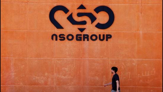 A man walks past the logo of Israeli cyber firm NSO Group at one of its branches in the Arava Desert, southern Israel. (REUTERS)