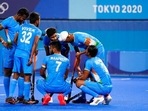 India's Manpreet Singh (7) huddles with his teammates.