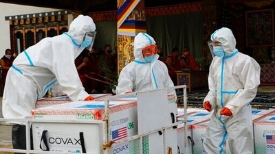 This photograph provided by Unicef shows airport personnel in protective suits handle unloaded consignment as 500,000 doses of Moderna Covid-19 vaccine gifted from the United States arrived at Paro International Airport in Bhutan, July 12, 2021. (Unicef via AP) This photograph provided by Unicef shows airport personnel in protective suits handle unloaded consignment as 500,000 doses of Moderna Covid-19 vaccine gifted from the United States arrived at Paro International Airport in Bhutan, July 12, 2021. (Unicef via AP)
