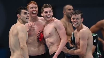 (From L) Britain's James Guy, Britain's Tom Dean, Britain's Duncan Scott and Britain's Matthew Richards react after winning the final of the men's 4x200m freestyle relay swimming event during the Tokyo 2020 Olympic Games at the Tokyo Aquatics Centre in Tokyo on July 28, 2021. (Photo by Oli SCARFF / AFP) (AFP) (From L) Britain's James Guy, Britain's Tom Dean, Britain's Duncan Scott and Britain's Matthew Richards react after winning the final of the men's 4x200m freestyle relay swimming event during the Tokyo 2020 Olympic Games at the Tokyo Aquatics Centre in Tokyo on July 28, 2021. (Photo by Oli SCARFF / AFP) (AFP)