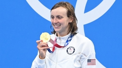 Gold medallist USA's Kathleen Ledecky poses on the podium after the final of the women's 1500m freestyle swimming event during the Tokyo 2020 Olympic Games at the Tokyo Aquatics Centre in Tokyo on July 28, 2021. (Photo by Attila KISBENEDEK / AFP) (AFP) Gold medallist USA's Kathleen Ledecky poses on the podium after the final of the women's 1500m freestyle swimming event during the Tokyo 2020 Olympic Games at the Tokyo Aquatics Centre in Tokyo on July 28, 2021. (Photo by Attila KISBENEDEK / AFP) (AFP)
