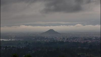 Rain clouds hover over the city in the outskirts of Srinagar on Wednesday. (AP)