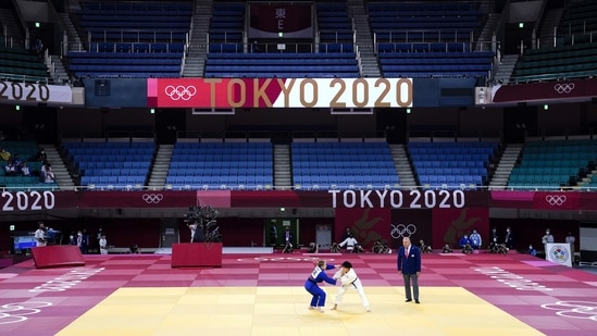 Lin Chen-hao of Taiwan and Shira Rishony of Israel compete in a women's 48-kg match with no spectators attending at the Tokyo 2020 Summer Olympics, on July 24. After being delayed by a year, the Tokyo Games have gone ahead without spectators as an unprecedented measure designed to avoid a superspreader event and reassure a nervous Japanese public.(Jae C. Hong / AP)