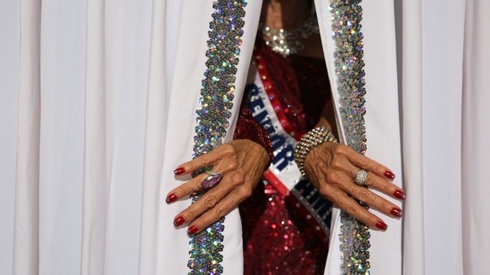 Debbie Carroll Boyce, Ms. Senior America 2011, pulls back the curtains on the stage at the Ms. Texas Senior America Pageant in Dallas, Texas, U.S., July 24, 2021. (REUTERS)