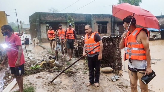 Samba: Three children of village Mananu Nud, rescued by SDRF team who trapped in flash flood adjoining to river Basanter in Samba district, Wednesday, (PTI)