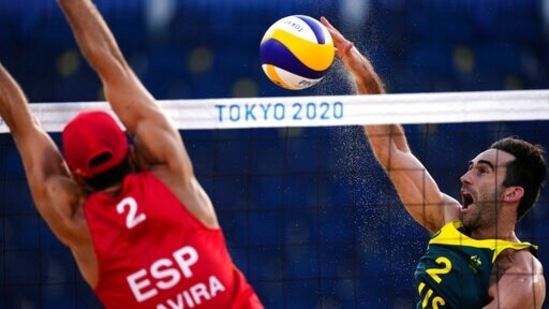 Damien Schumann, right, of Australia, takes a shot as Adrian Gavira Collado, of Spain, defends during a men's beach volleyball match against at the 2020 Summer Olympics, Wednesday, July 28, 2021, in Tokyo, Japan. (AP Photo/Petros Giannakouris)(AP)
