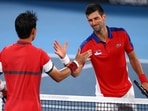 Tokyo 2020 Olympics: Novak Djokovic of Serbia shakes hands with Kei Nishikori of Japan after winning his quarterfinal match.