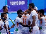 India's Haanpreet Singh (13) celebrates with his teammates after scoring on Argentina goalkeeper Juan Manuel Vivaldi during a men's field hockey match at the 2020 Summer Olympics, Thursday, July 29, 2021, in Tokyo, Japan. 