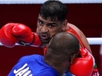 Satish Kumar, top, of India exchanges punches with Ricardo Brown of Jamaica during their men's super-heavy weight 91 kg preliminaries round Boxing match at the 2020 Summer Olympics, Thursday, July 29, 2021, in Tokyo, Japan. 