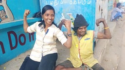 The image shows Manisha Krishnasamy with a person she is helping.