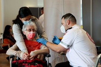 An elderly woman receives a booster shot of her vaccination against the coronavirus disease (COVID-19) at an assisted living facility, in Netanya, Israel (REUTERS) An elderly woman receives a booster shot of her vaccination against the coronavirus disease (COVID-19) at an assisted living facility, in Netanya, Israel (REUTERS)