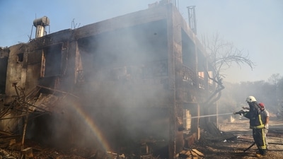 A firefighter cools a burnt house as a massive forest fire spread to the town of Manavgat, 75 km (45 miles) east of the resort city of Antalya, Turkey on July 28.  (REUTERS/Kaan Soyturk)