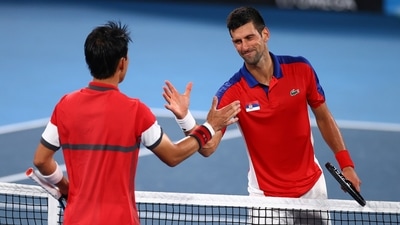 Tokyo 2020 Olympics: Novak Djokovic of Serbia shakes hands with Kei Nishikori of Japan after winning his quarterfinal match. (REUTERS)