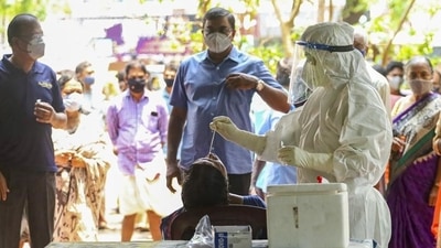 Health workers take swab samples for Covid-19 testing as cases surge in Kerala. (PTI) Health workers take swab samples for Covid-19 testing as cases surge in Kerala. (PTI)