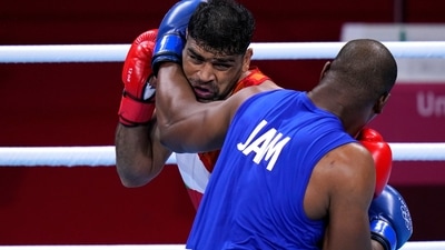 Satish Kumar, center left, of India exchanges punches with Ricardo Brown of Jamaica during their men's super-heavy weight 91 kg preliminaries round Boxing match at the 2020 Summer Olympics, Thursday, July 29, 2021, in Tokyo, Japan. (AP Photo/Frank Franklin II) (AP)