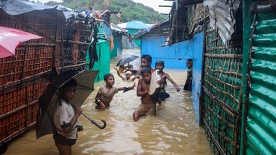 Rohingya refugee children play in flood waters at the Rohingya refugee camp in Kutupalong, Bangladesh. (AP) Rohingya refugee children play in flood waters at the Rohingya refugee camp in Kutupalong, Bangladesh. (AP)