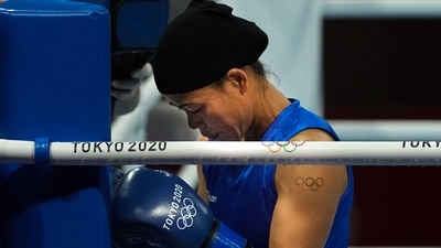 Mary Kom prays before the start of her bout against Ingrit Valencia of Columbia in women's Fly (48-51kg) boxing Round of 16, at the Summer Olympics 2020. (PTI)