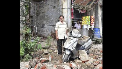 Building owner Ashok Behal standing next to his damaged scooter at the spot where a portion of a building collapsed near Deepak Cinema road in Ludhiana on Thursday. (GURPREET SINGH/HT) Building owner Ashok Behal standing next to his damaged scooter at the spot where a portion of a building collapsed near Deepak Cinema road in Ludhiana on Thursday. (GURPREET SINGH/HT)