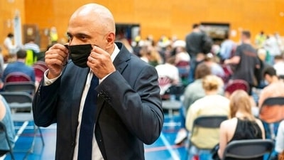 Britain's health secretary Sajid Javid speaks to the media during a visit to a pop-up vaccination site in west London, on Wednesday. (AP Photo)