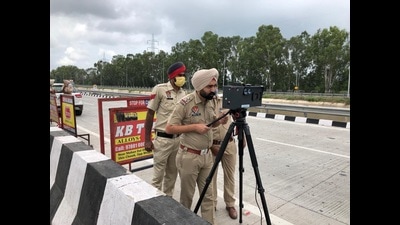 The traffic police using a LiDAR sensor to measure the speed of vehicles and generate e-challans in Ludhiana on Thursday. (HT PHOTO) The traffic police using a LiDAR sensor to measure the speed of vehicles and generate e-challans in Ludhiana on Thursday. (HT PHOTO)