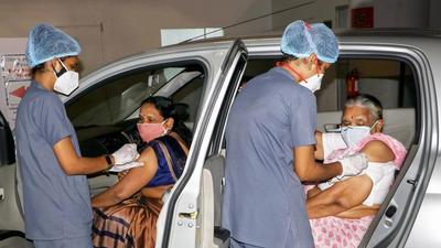 Health workers give a dose of Covid-19 vaccine to elderly women at a drive-in vaccination center in Nagpur. (PTI) Health workers give a dose of Covid-19 vaccine to elderly women at a drive-in vaccination center in Nagpur. (PTI)