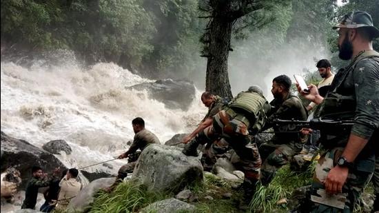 Army personnel during a rescue operation after flash floods due to a cloudburst at Honjar in Kishtwar district. (PTI)