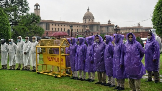 Security personal wearing raincoats while on guard amid rain at Vijay Chowk in New Delhi on July 28. Having already logged the highest precipitation for the month in 18 years, Kuldeep Srivastava, head of India Meteorological Department’s regional weather forecasting centre, suggests another spell of moderate rainfall is likely to hit the city between July 30 and 31.(ANI)